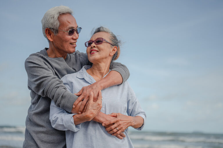 Senior couple on beach enjoying retirement