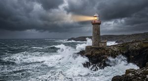 A lighthouse standing firm in a storm, illustrating the discipline required for navigating market volatility in retirement.